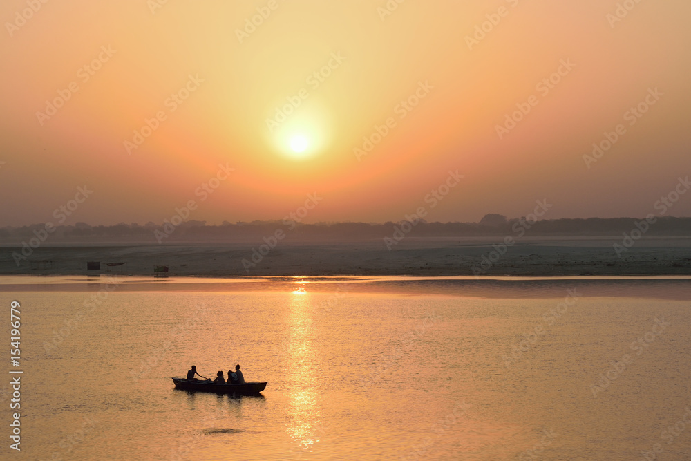 Tourists on wooden boats at Ganges river in Varanasi, India