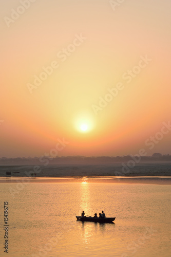 Tourists on wooden boats at Ganges river in Varanasi, India