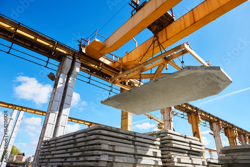 Fotografija Construction industrial worker operating hoisting process of concrete slab