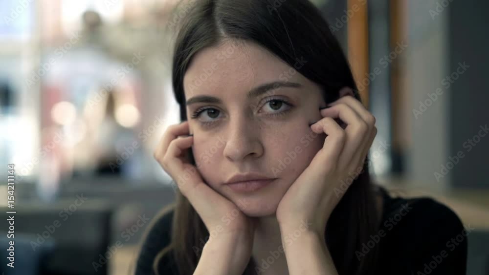 Portrait of worried, unhappy girl sitting in cafe
Portrait of worried, unhappy girl sitting in cafe