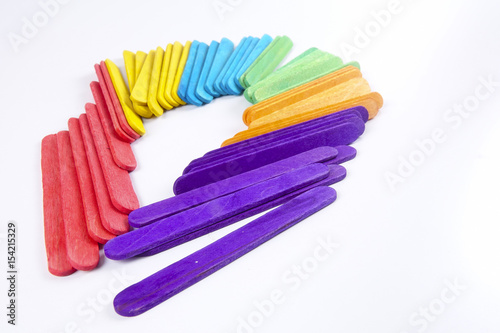 Colourful wooden sticks on white background