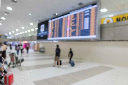 Canvas Print Blurred background of people traveling in Airport with departure board