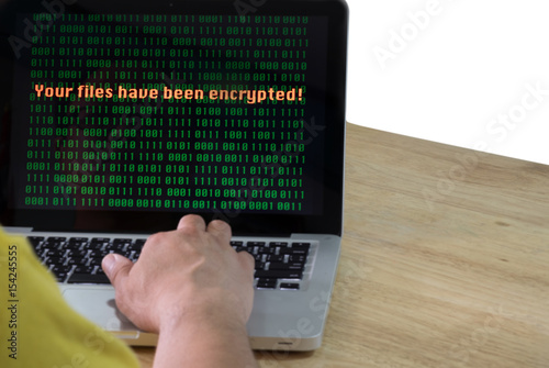 Laptop can not access the file its show message Your files have been encrypted on display for malware; hacker; online ransom; virus; network risk system concept