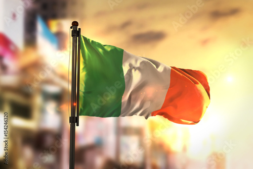 Photography Ireland Flag Against City Blurred Background At Sunrise Backlight