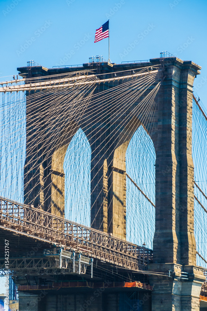 Fototapeta premium American flag on top of Brooklyn Bridge New York
