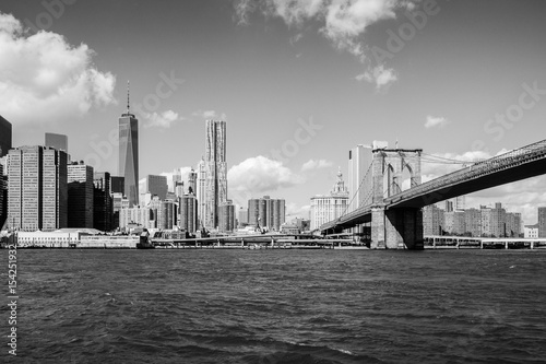 Brooklyn bridge leading to the center of Manhattan New York black white