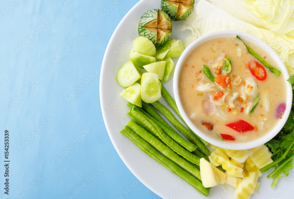 Salted crab stew with vegetables around a white plate concept for healthy; Thai; ASIAN foods Salted crab stew with vegetables around a white plate concept for healthy; Thai; ASIAN foods