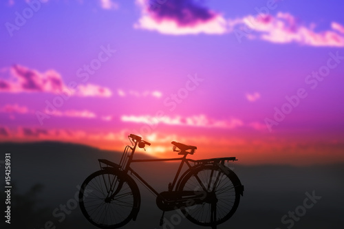 silhouette of bicycle with blurred background sunset