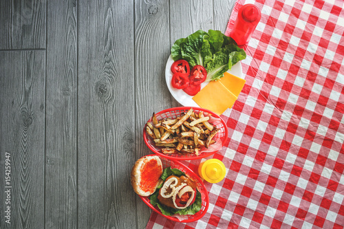 Summer cooking tabletop with homemade hamburgers and frenchfries