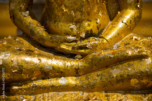 gold plates on buddha,The Buddha statue to gild with gold leaf. photo