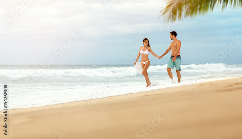 loving couple enjoying and walk on beach © luckybusiness