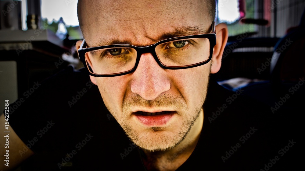Young man in blue glasses Young man in blue glasses
