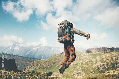 Traveler Man jumping levitation with heavy backpack at mountains Lifestyle Travel happy emotional success concept adventure active vacations outdoor .