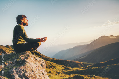 Man meditating yoga at mountains Travel Lifestyle relaxation emotional concept adventure summer vacations outdoor harmony with nature landscape