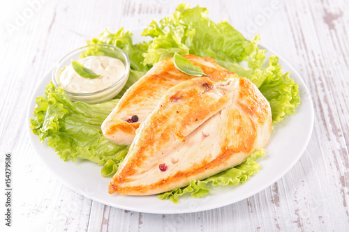 grilled chicken breast with salad and sauce