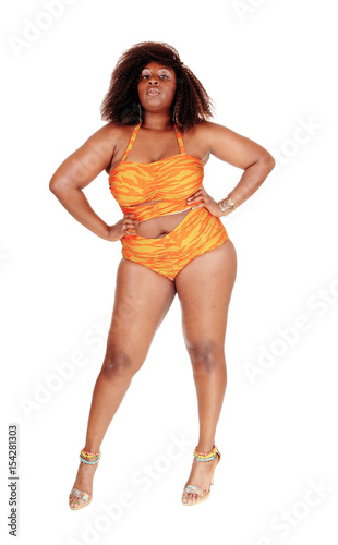 African woman in bikini hands on hip.