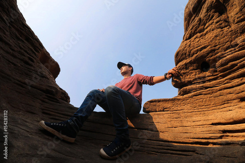 young man climbing on the rock