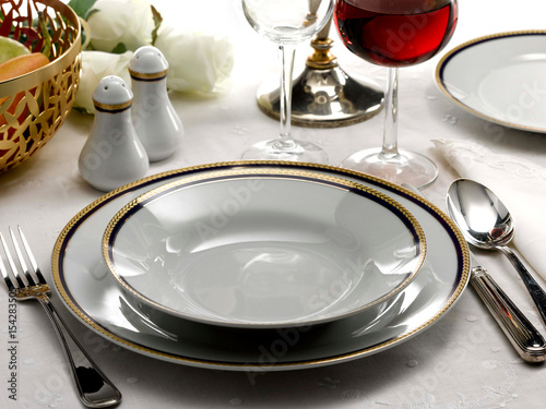 table set for dinner, one place gold rimmed plates