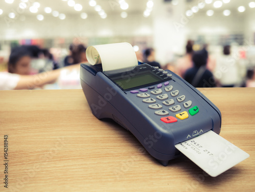 Credit card terminal or EDC machine on wooden background photo