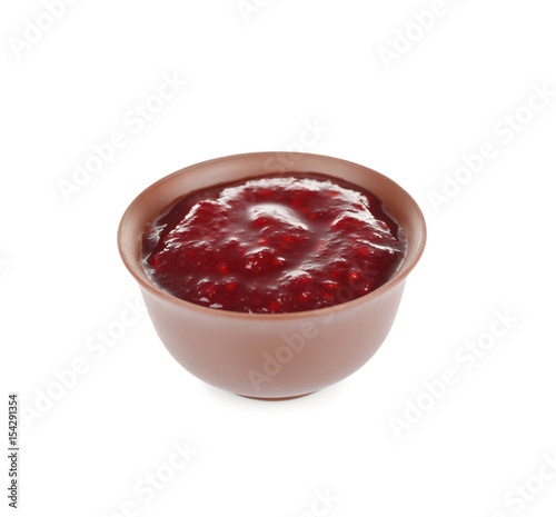 Bowl of delicious berry sauce isolated on white