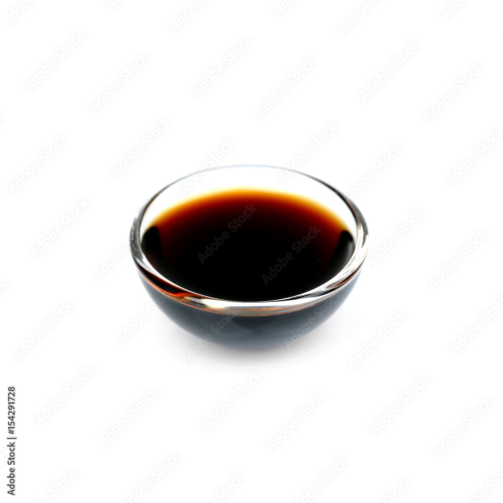 Bowl of delicious soy sauce isolated on white