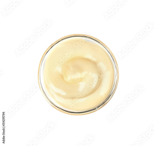 Bowl of delicious creamy sauce isolated on white