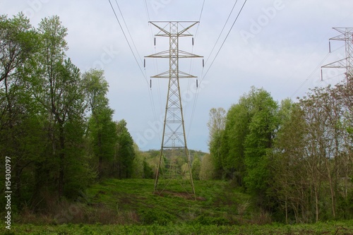 The power towers in the green grass field.