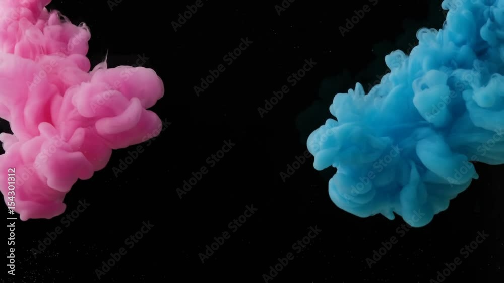 Color drop in water, Ink swirling in water. Cloud of silky ink in water isolated on black background. Colorful ink in water, ink drop. Violet, blue, pink.