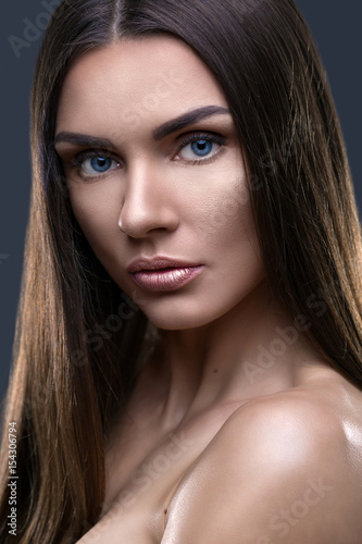 Portrait of beautiful woman with glistening hair in studio