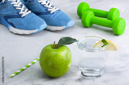 Sport composition with sports equipment glass water apple