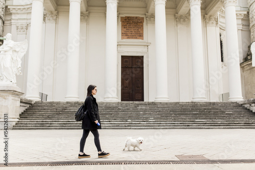 Woman walking with a dog on...