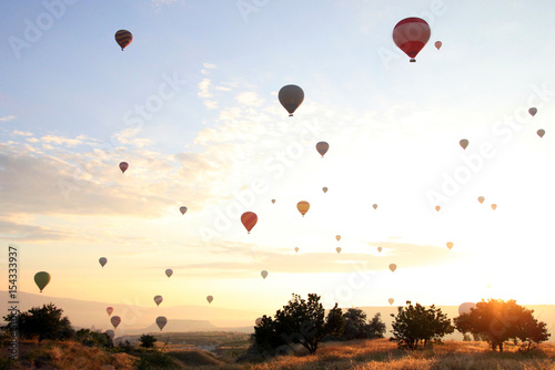 Travel to Goreme, Cappadocia, Turkey. The sunrise in the mountains with a lot of air hot balloons in the sky.