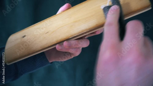 polishing wooden plank with sandpaper. photo