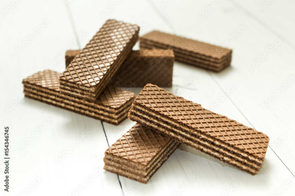 A slice of chocolate wafers on a white table, a snack. A slice of chocolate wafers on a white table, a snack.