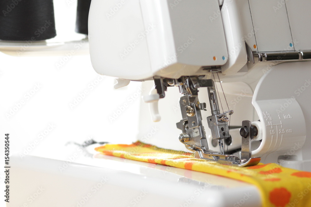 Overlock sewing machine - sideview on upper mechanics -  foreground and background blanked ot blurry