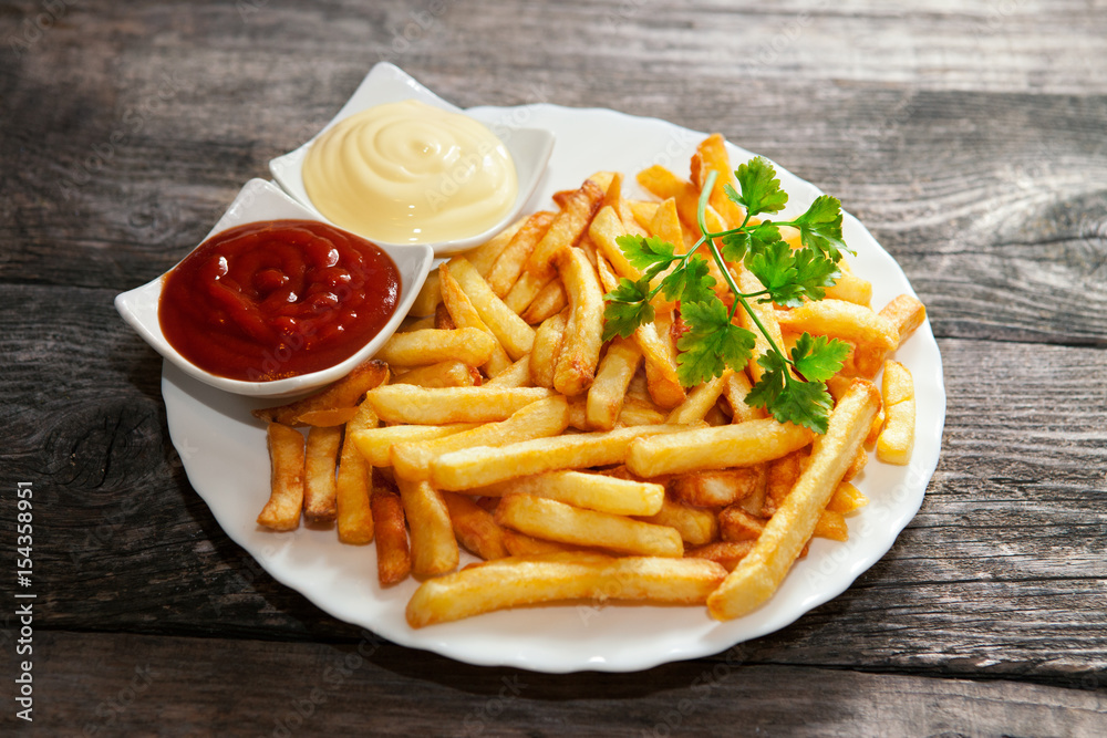 French fries with tomato sauce, mayonnaise and parsley French fries with tomato sauce, mayonnaise and parsley