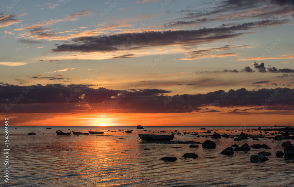 sunset at the baltic sea with boats