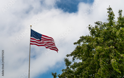 American flag waiving on a wind outside on a cloudy day