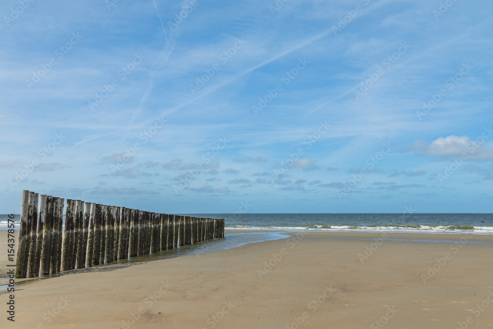 Lonesome Beach Of North Sea With Wooden Wave Breakers In The Morning - Timber Piles - Netherlands