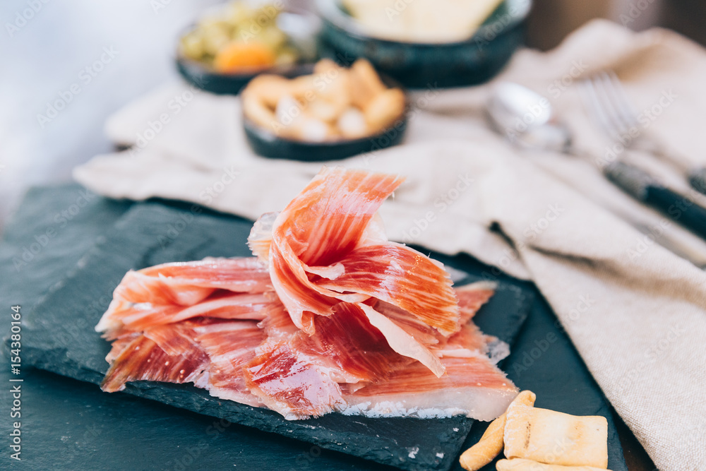 Fotografie Spanish ham over black booard