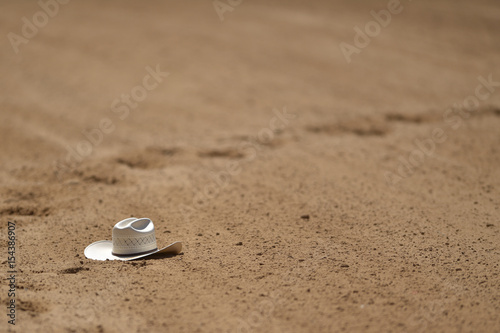 Cowboy hat on the sand