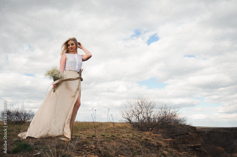 Portrait of beautiful blond woman in a field