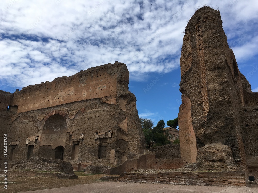 Second largest Roman public bath house at Caracalla in Rome, Italy.  Blue sky with wispy clouds on a hot summer day.