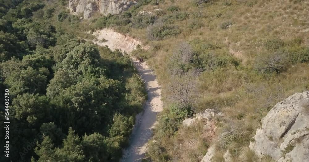 Aerial video shot by a drone of a trekking to the top of the mountain at sunset. Emerald coast, Sardinia, Italy. Aerial video shot by a drone of a trekking to the top of the mountain at sunset. Emerald coast, Sardinia, Italy.