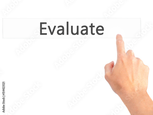 Evaluate - Hand pressing a button on blurred background concept on visual screen.