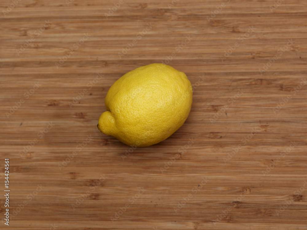 Single lemon on cutting board