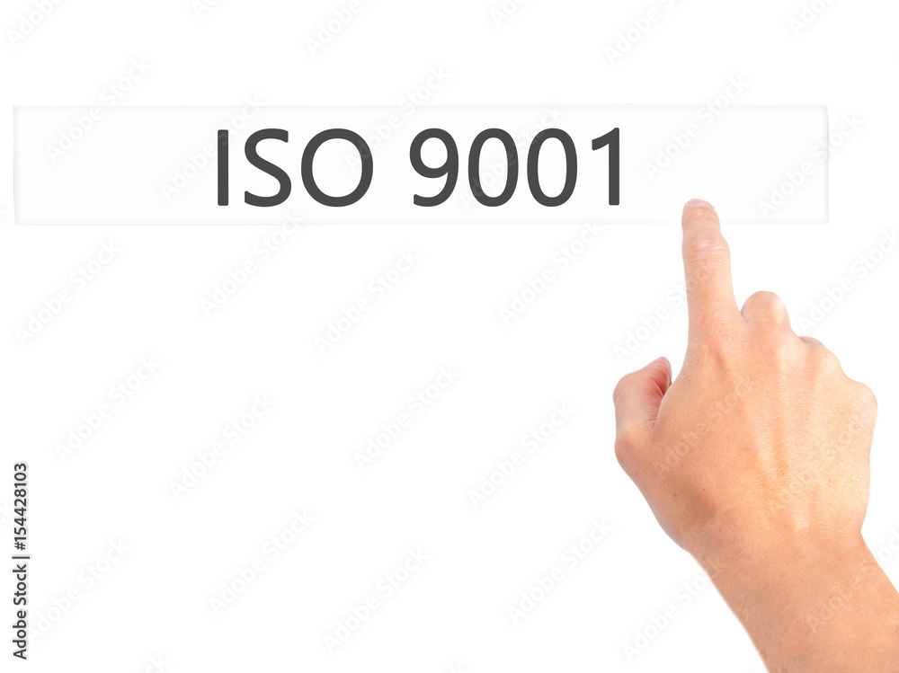 ISO 9001 - Hand pressing a button on blurred background concept on visual screen. ISO 9001 - Hand pressing a button on blurred background concept on visual screen.