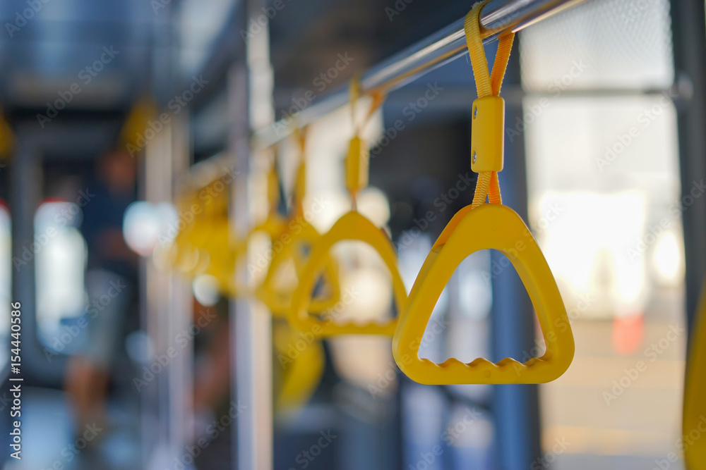 Handle on ceiling of bus train, MRT, prevent toppling.underground railway system or metro,selective focus,vintage color Handle on ceiling of bus train, MRT, prevent toppling.underground railway system or metro,selective focus,vintage color