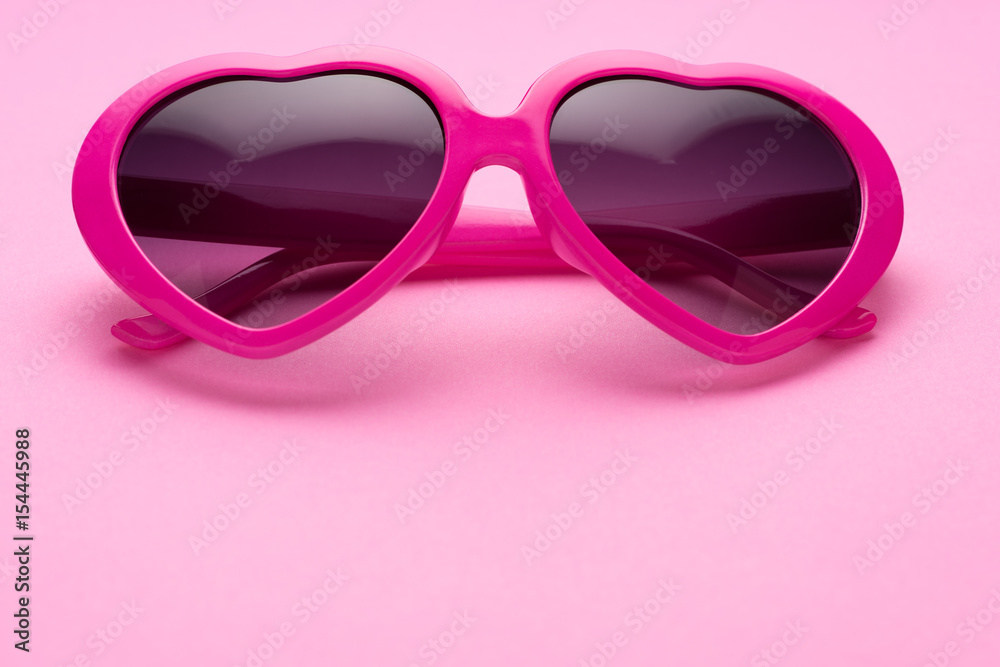 pink heart-shaped sunglasses isolated on pink background pink heart-shaped sunglasses isolated on pink background