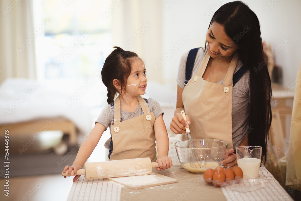 Mother and daughter cooking